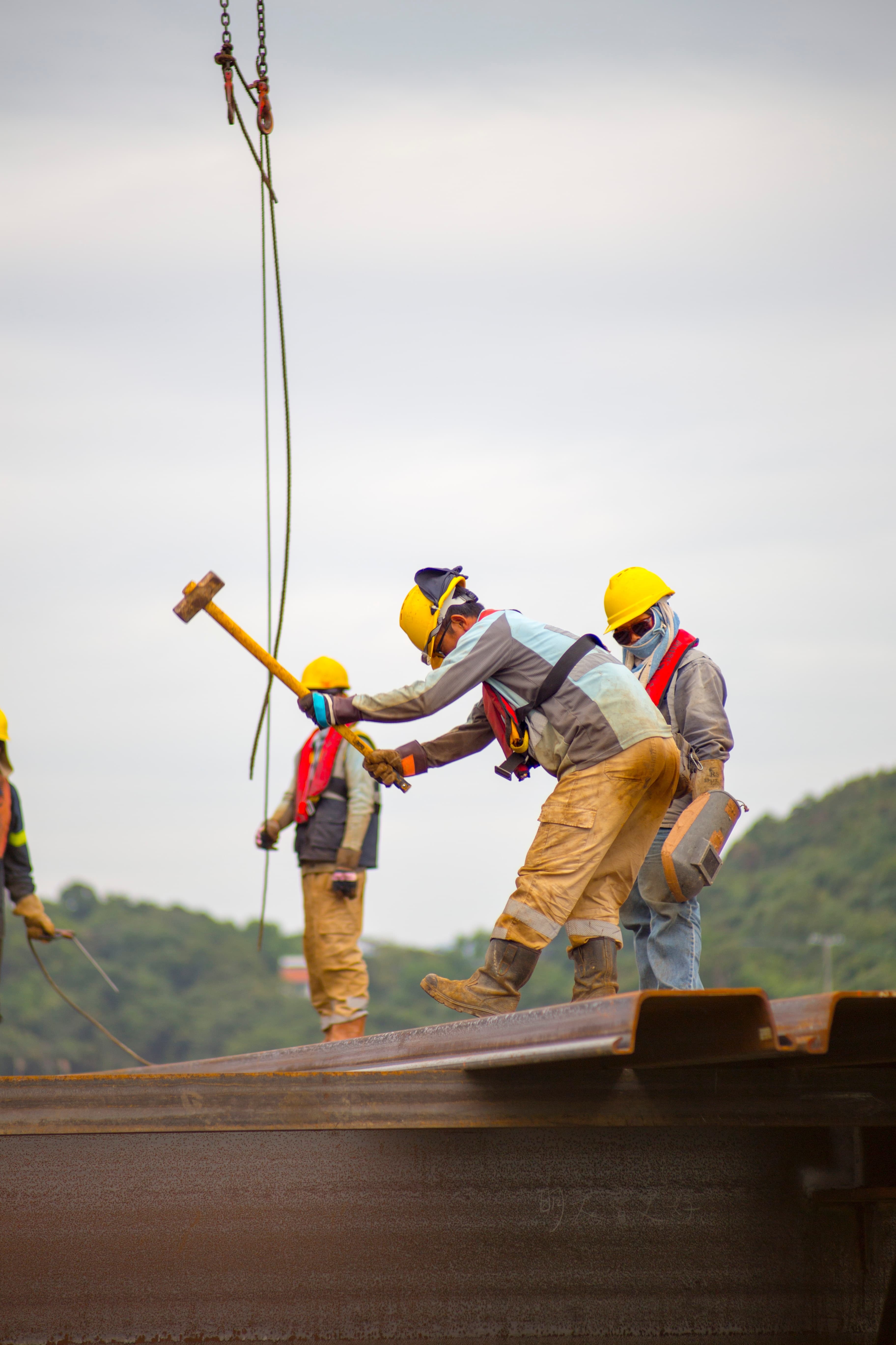 Construction working using a sledge hammer